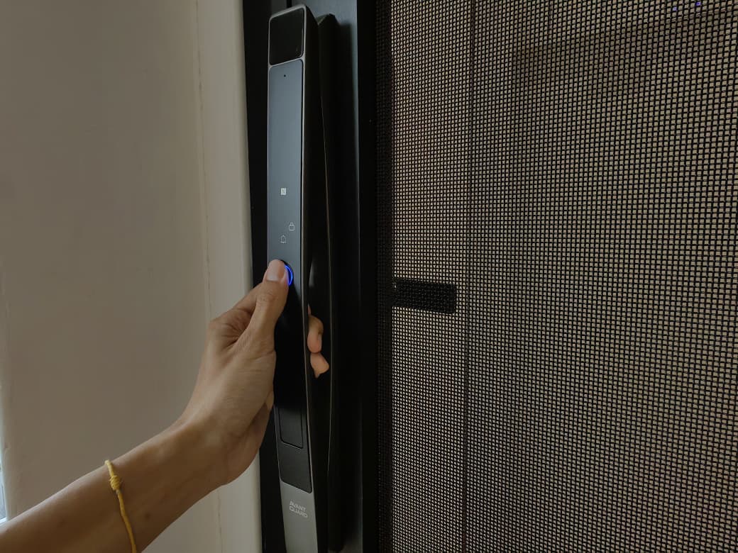 Hand reaching for an Avant Guard digital door lock